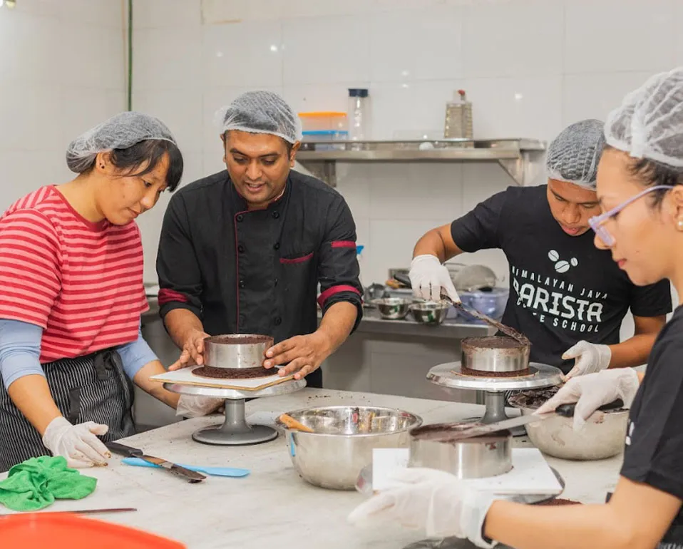 A baker shaping dough during the Himalayan Java bakery training course.